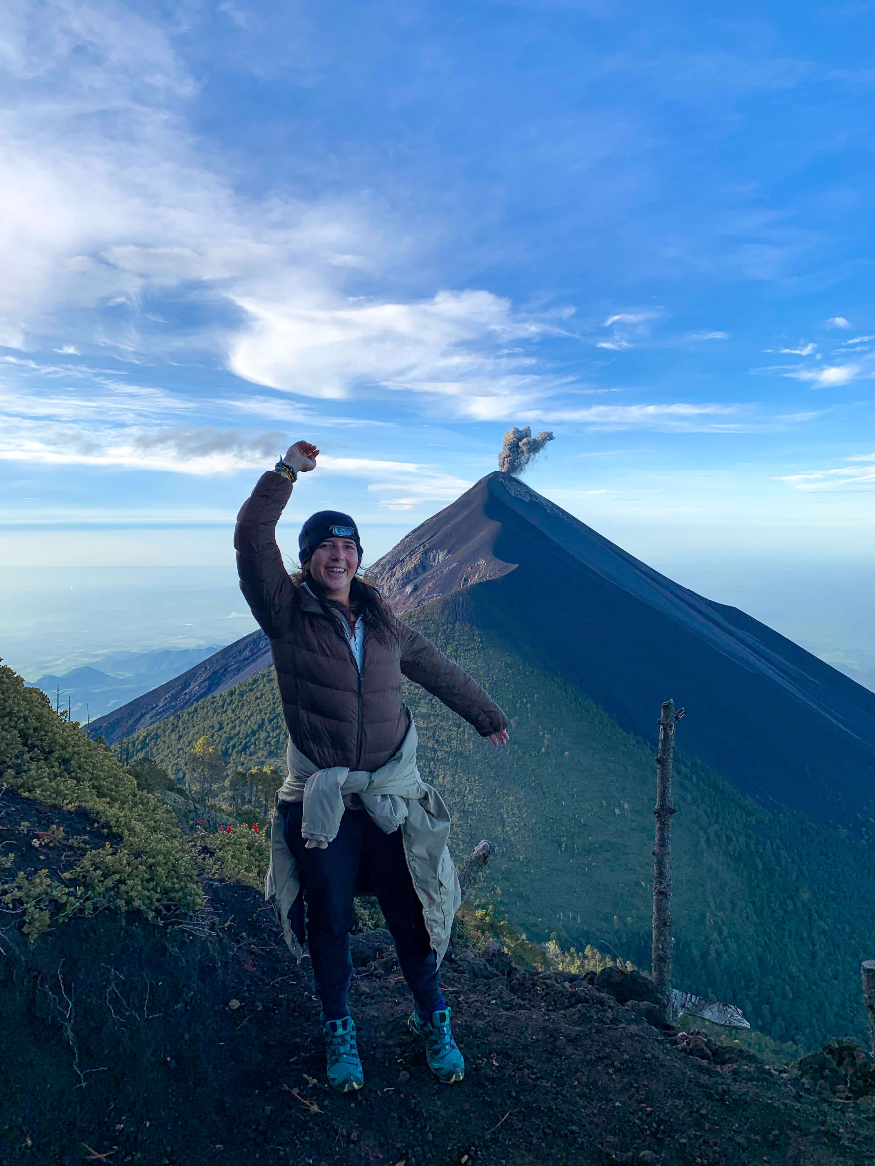 Maïlys in front of a volcanic eruption seen from Acatenango in Guatemala