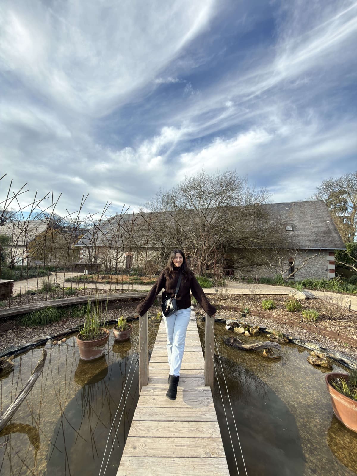 Maïlys, your travel planner, on a footbridge over a pond in the gardens of Chaumont-sur-Loire